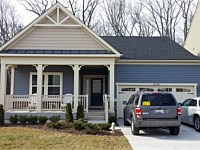 <b>Square Vinyl Columns with decorative touches and tan vinyl railing attached to concrete porch flooring</b>