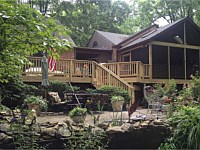 <b>Screened Porch with a gable style roof. This screened porch looks as if it was built with the house.  The porch and deck are made from pressure treated wood, and have skylights in the ceiling for extra natural light during the day.</b>