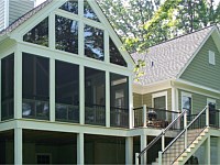 <b>Screened Porch with a gable style roof. Eze-Breeze Sliding Panel System is installed on the porch, allowing you to use your room all year round. In this photo, the panels are all slid to the bottom for open breezes. The top gable area is finished in glass. The deck includes composite deck boards and bronze aluminum railing with white aluminum posts.</b>