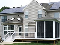 <b>This screened porch and deck combo includes composite deck boards, white vinyl railing with black aluminum balusters. The side of the deck is wrapped in white fascia. The screened porch has a hip style roof and uses ScreenEze with Super Screen Screening System.</b>