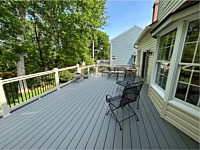 <b>Trex Composite deck boards in the color of Pebble Gray with tan vinyl railing and black round aluminum balusters in Annapolis, Maryland</b>